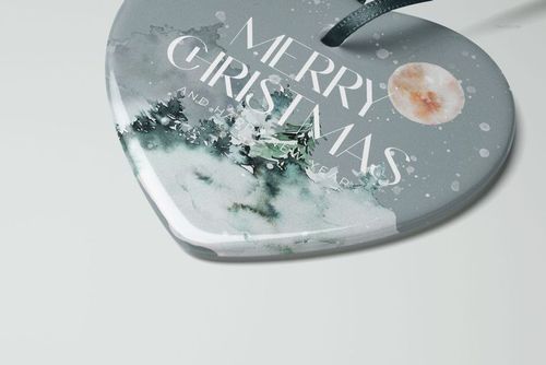 Heart-shaped ceramic Christmas ornament mockup with watercolor tree design, front view on light background.
