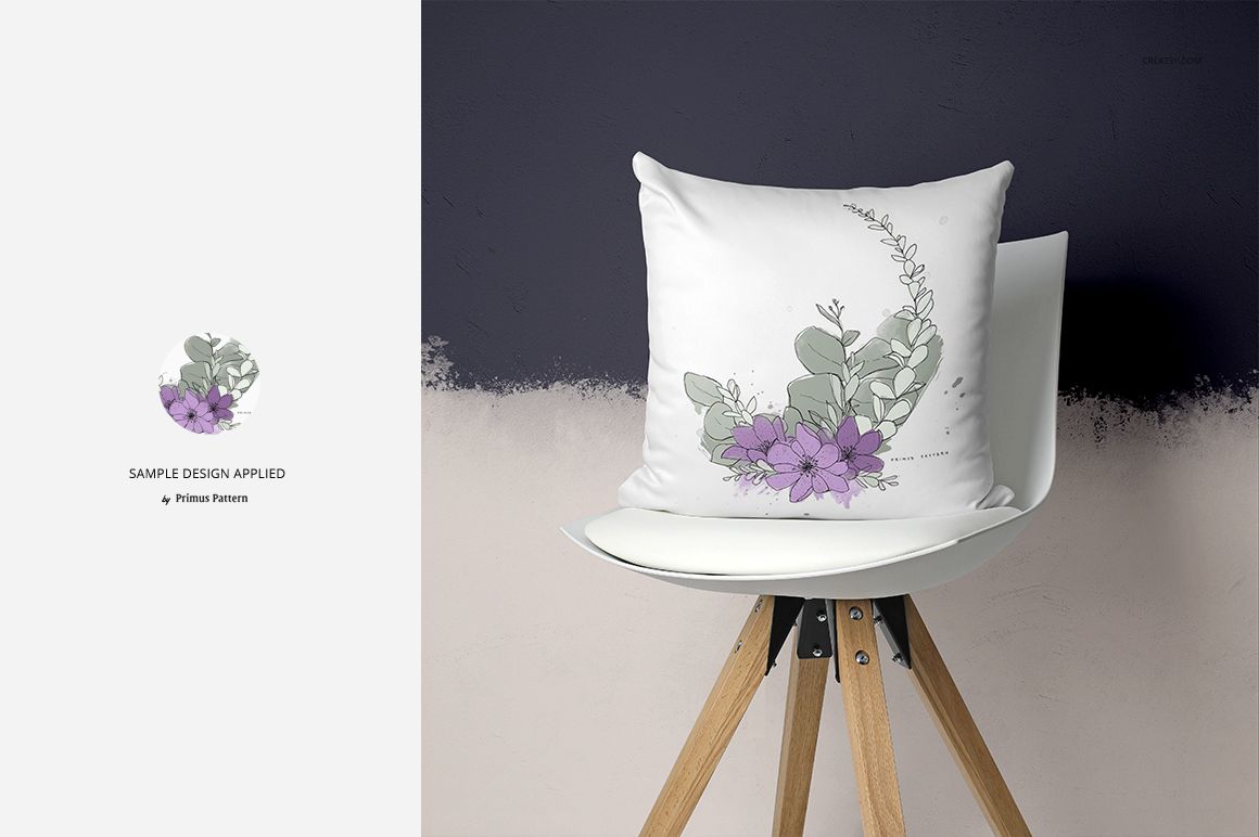 PSD mockup of a decorative pillow featuring a botanical design, displayed on a white chair with wooden legs in a minimalist room.