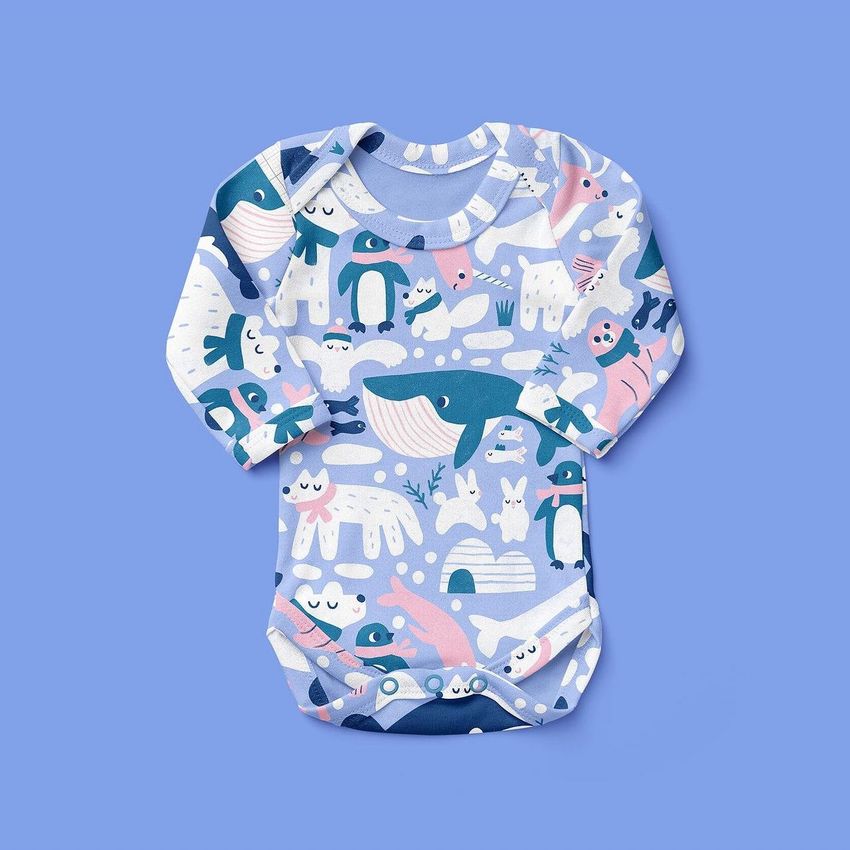 Baby long sleeve bodysuit mockup featuring a playful arctic animal pattern in blue, white, and pink on a solid blue background.