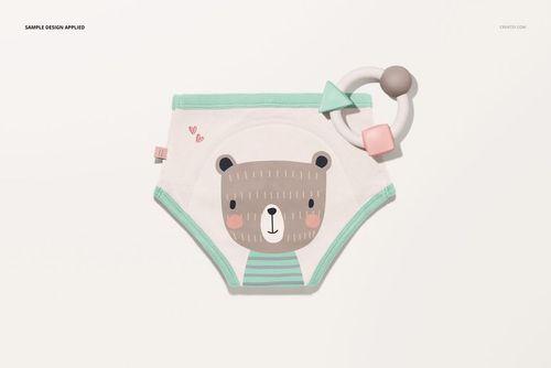 Toddler training pants mockup with a bear illustration, mint green trim, and a baby teething toy on a light background.