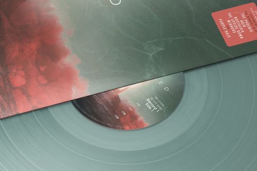 Close-up of a colored vinyl record mockup set, featuring a semi-transparent disc and a vibrant sleeve design.