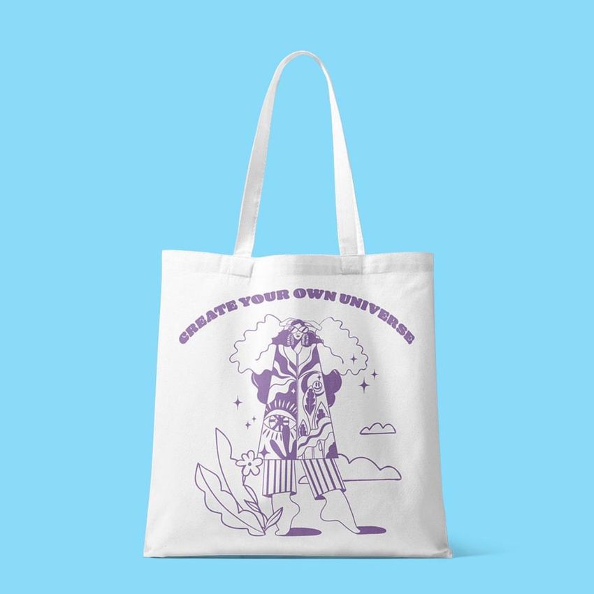 Tote bag mockup featuring a white bag with purple line art of a figure and plants, set against a solid light blue background.