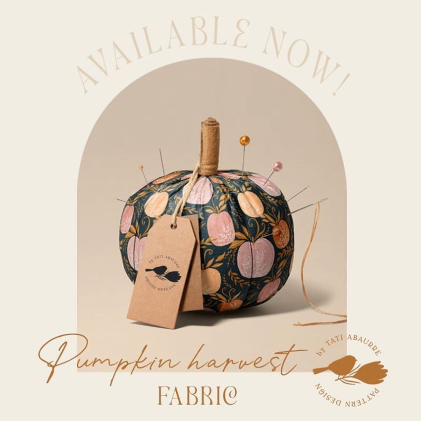 Fabric pumpkin mockup featuring a round pumpkin with a dark floral pattern, fabric tags, and sewing pins on a neutral background.