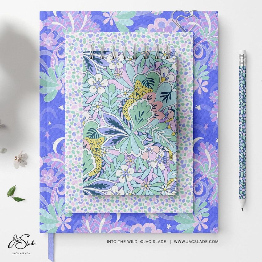 Stationery set mockup featuring a spiral notebook, a closed book, and a pencil with matching pastel floral and leopard patterns on a white surface.