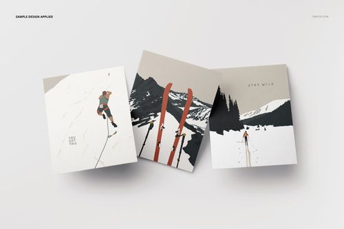 A2 cards mockup featuring three cards with mountain and skiing illustrations, shown from a top view on a pale surface.