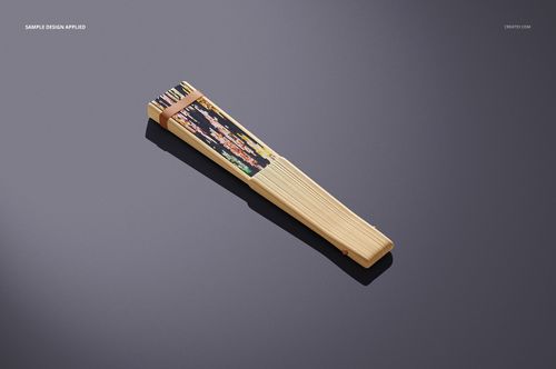 Fabric hand fan mockup featuring wooden slats and a decorative patterned section, displayed on a gray background.