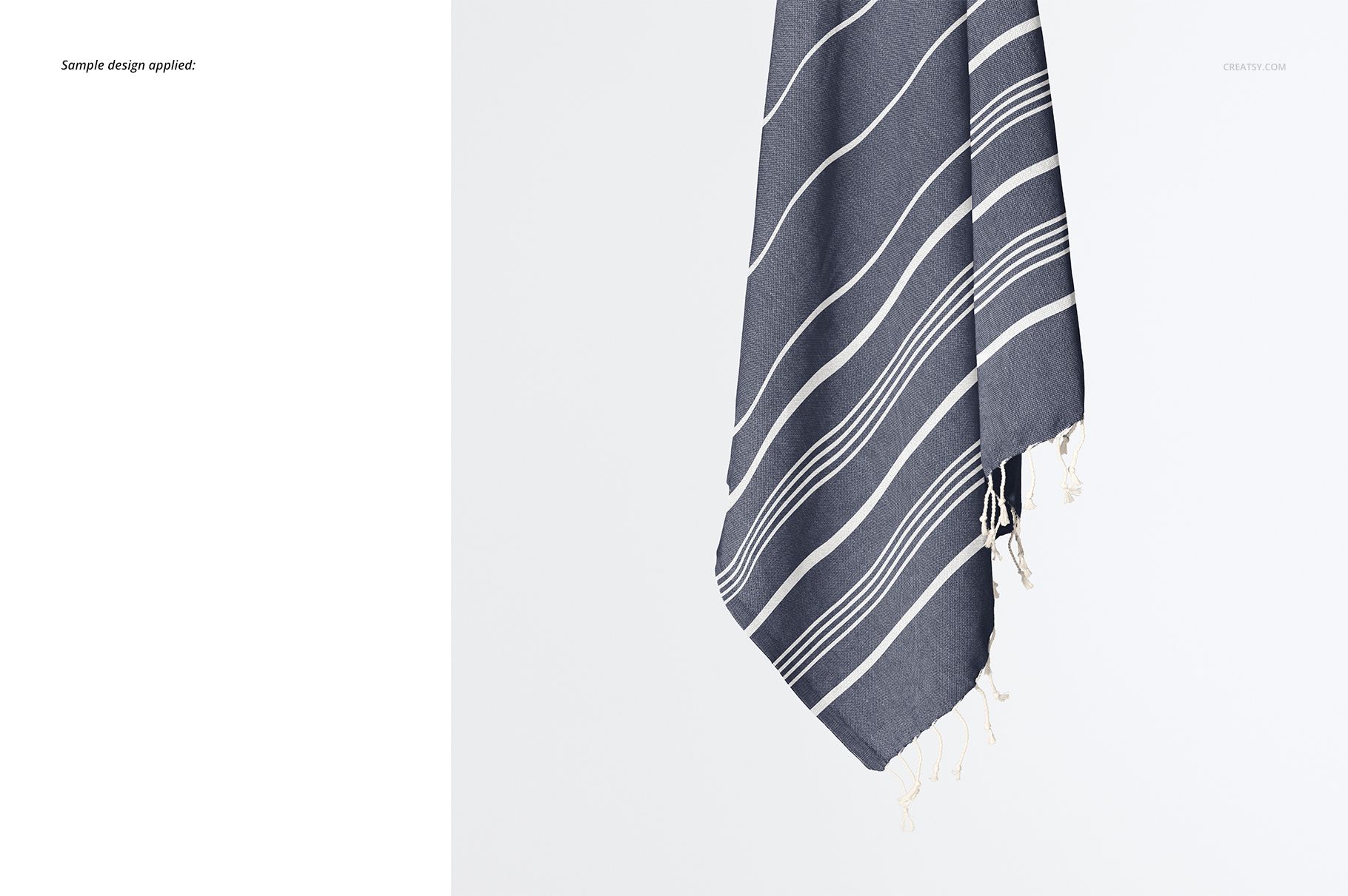 Dark gray Turkish towel mockup featuring white linear stripes and tassel edges, displayed from a side angle.