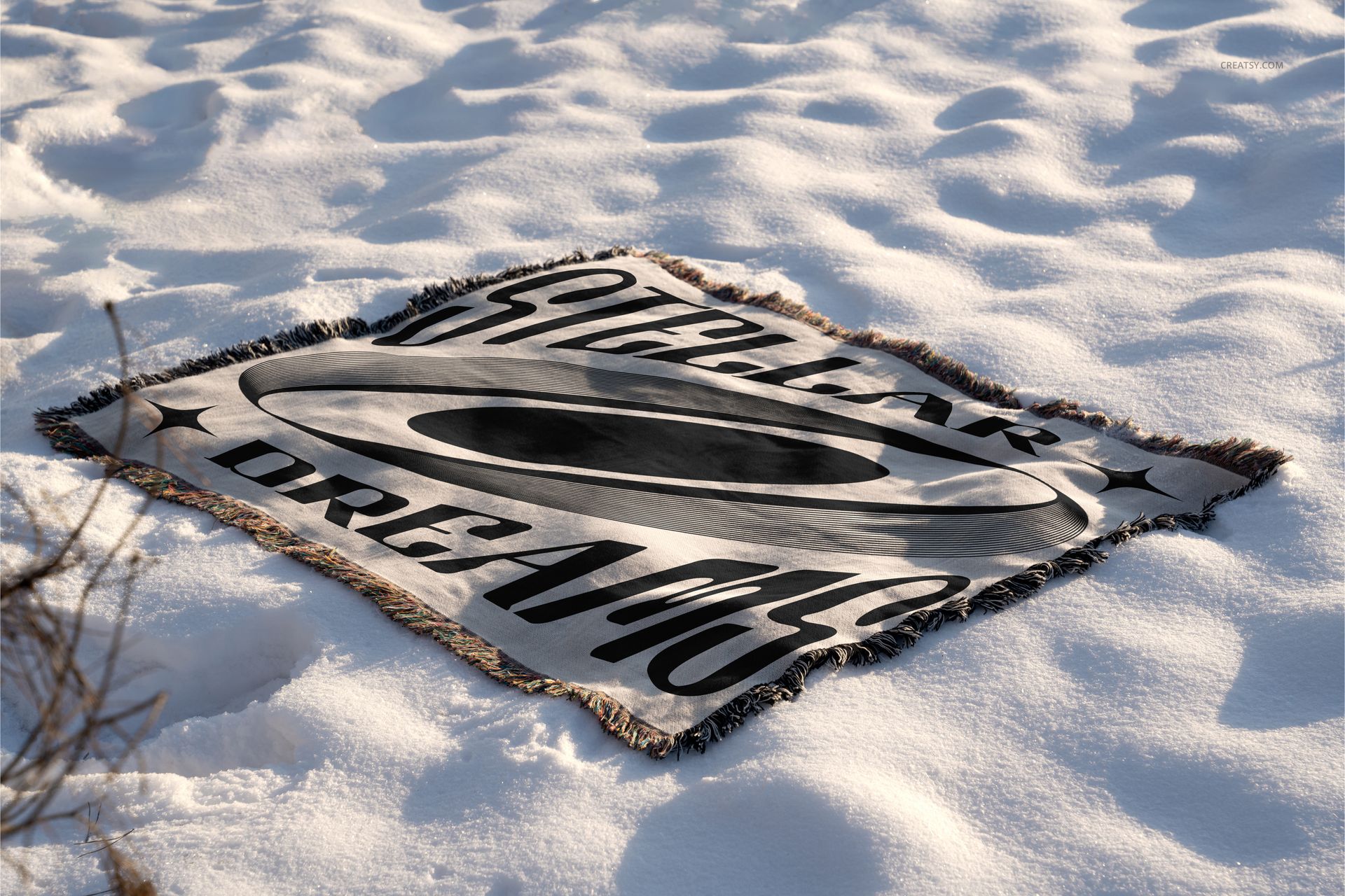 Winter-themed blanket mockup featuring a rectangular woven textile with fringed edges placed on snowy ground.