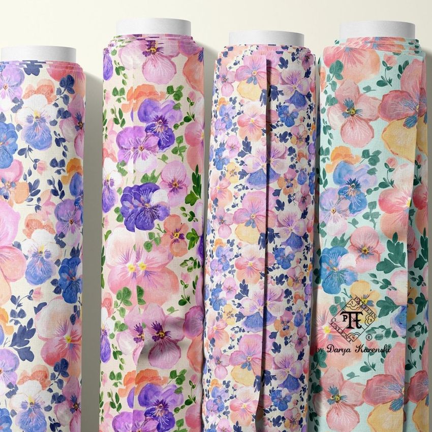 Fabric rolls mockup featuring four upright rolls with colorful pansy and floral patterns in pastel shades on a light background.