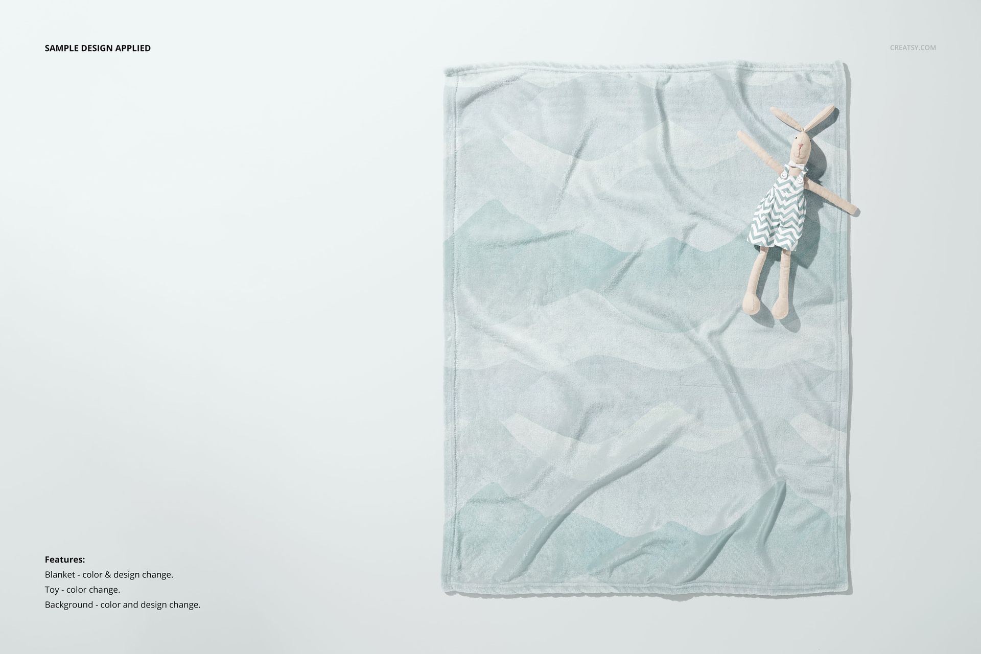Flat lay of a 30x40 fleece blanket mockup with soft pastel design, accompanied by a cloth bunny doll on the side.