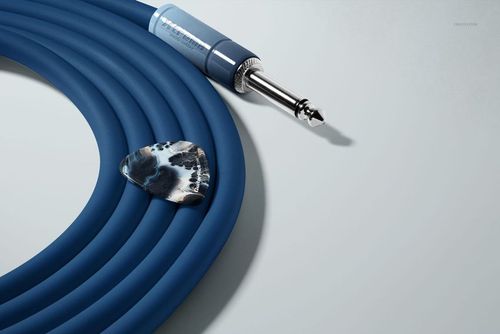 Close-up view of a guitar pick and coiled blue jack cable arranged on a pale background in a PSD mockup.