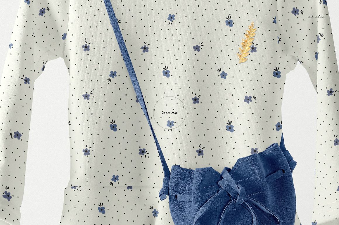 Front view of a baby dress mockup with long sleeves, white fabric, blue floral pattern, and small navy bag accessory.
