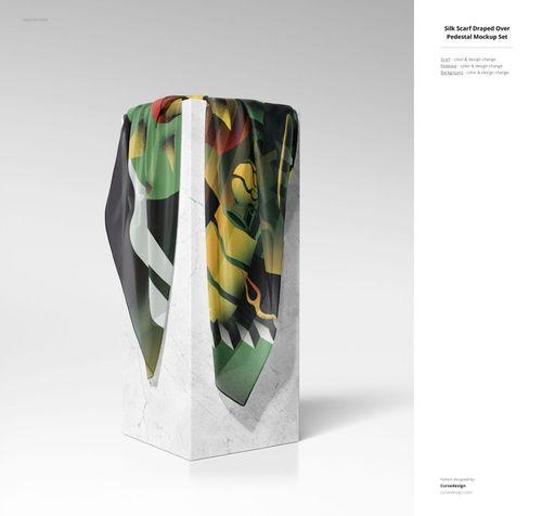 PSD mockup showing a patterned silk textile hanging over a vertical white stone pedestal against a plain background.