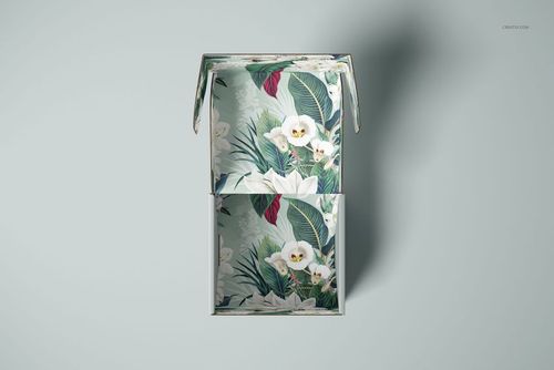 Front view of an open mailer box mockup with a floral pattern featuring white flowers and green leaves inside.