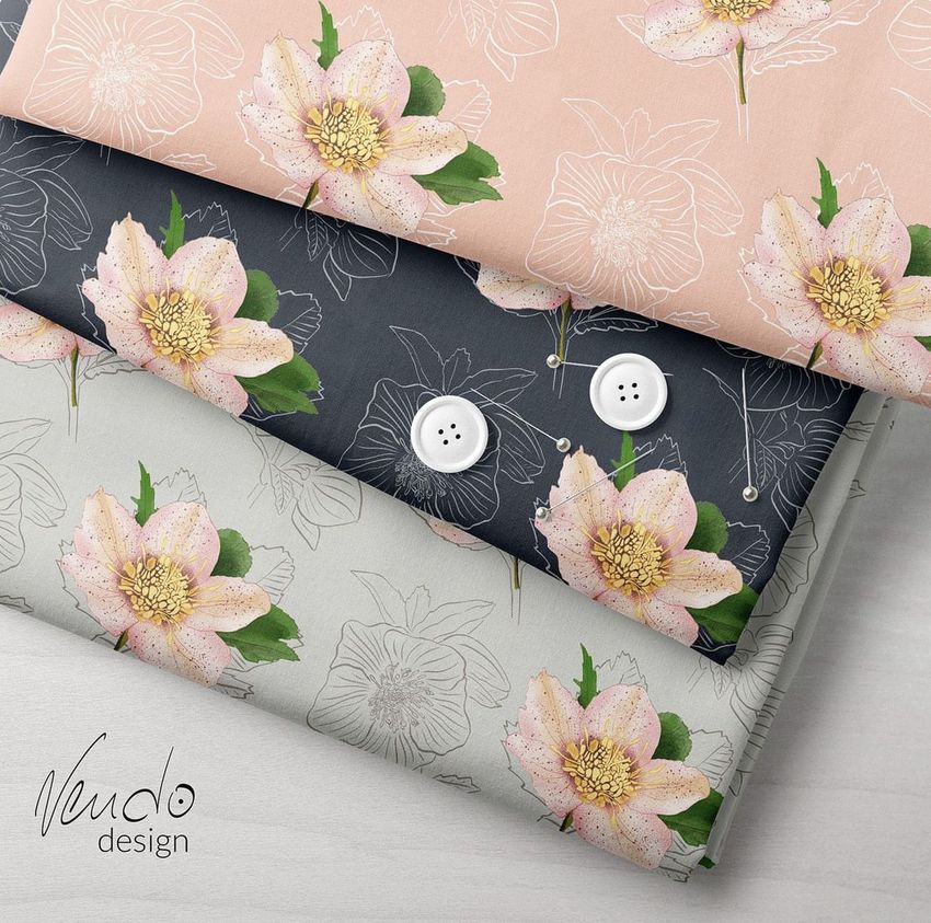 Folded fabric mockup featuring three stacked pieces with floral patterns in pink, dark gray, and light gray tones, shown from above.