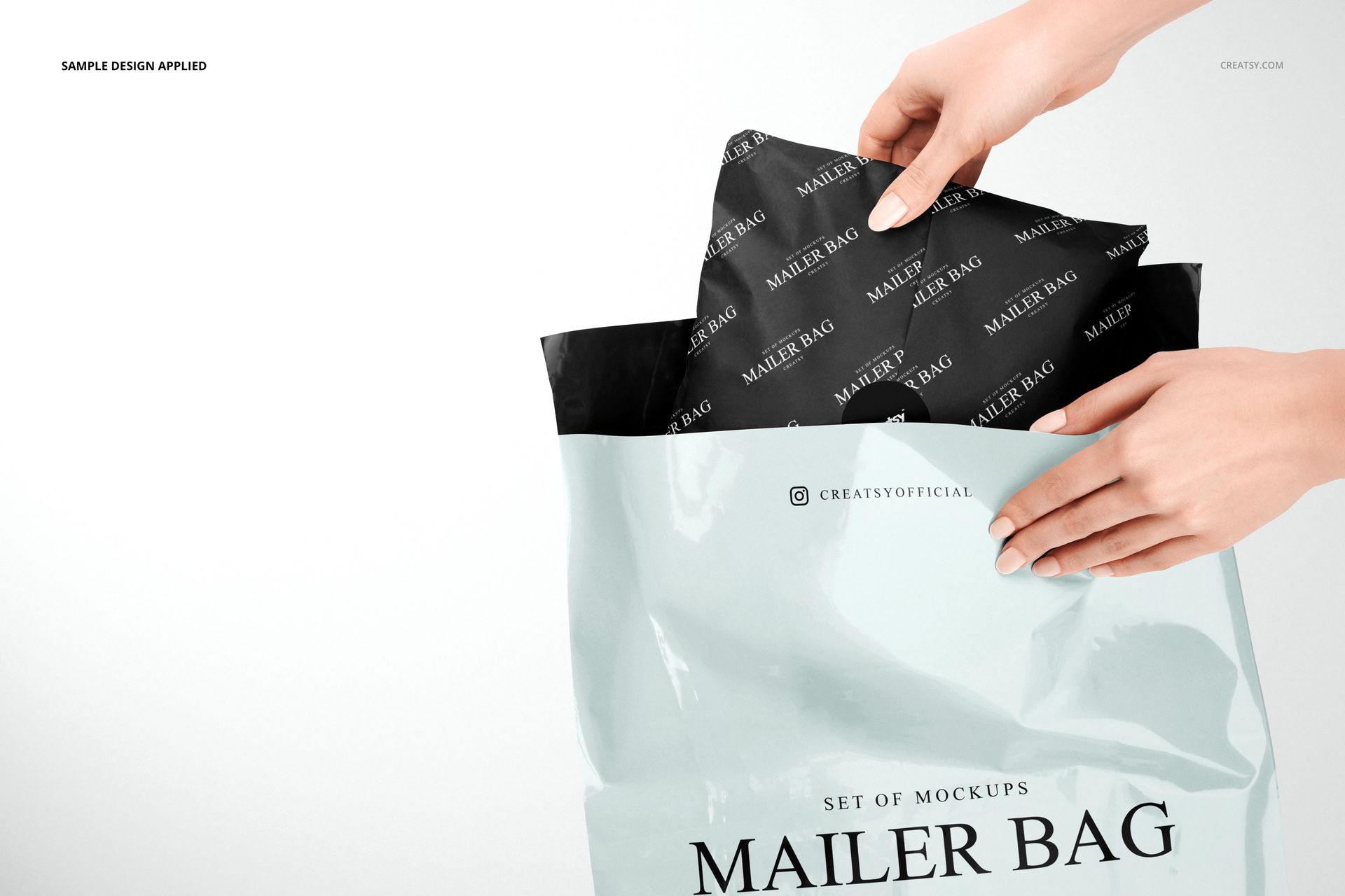 Close-up of a person inserting black wrapping tissue paper into a pastel blue mailer bag, mockup scene with clear branding.