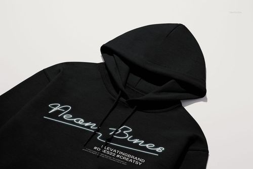 Gildan 18500 hoodie mockup showing a black pullover with drawstrings and printed text, photographed from above.