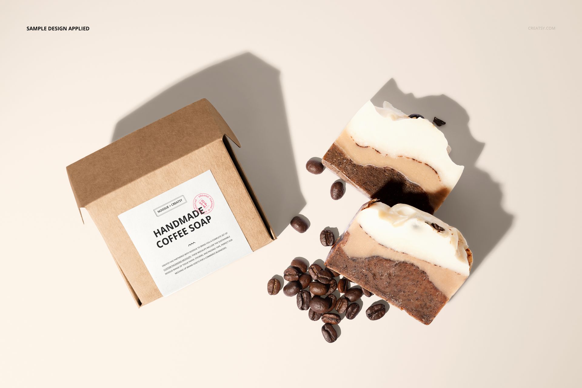 Front view of a brown coffee soap box mockup with a label, accompanied by sliced soap bars and coffee beans.