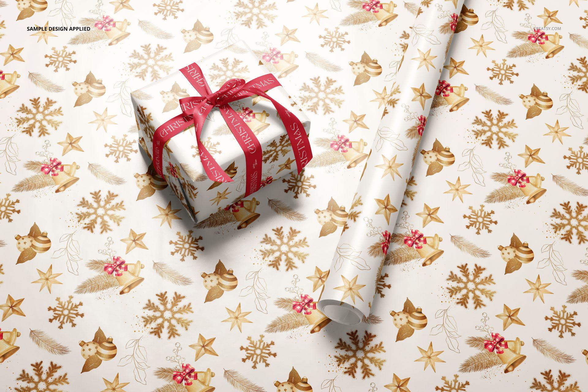 Gift wrapping paper mockup featuring a rolled sheet and a wrapped box with festive gold and brown patterns, top view.