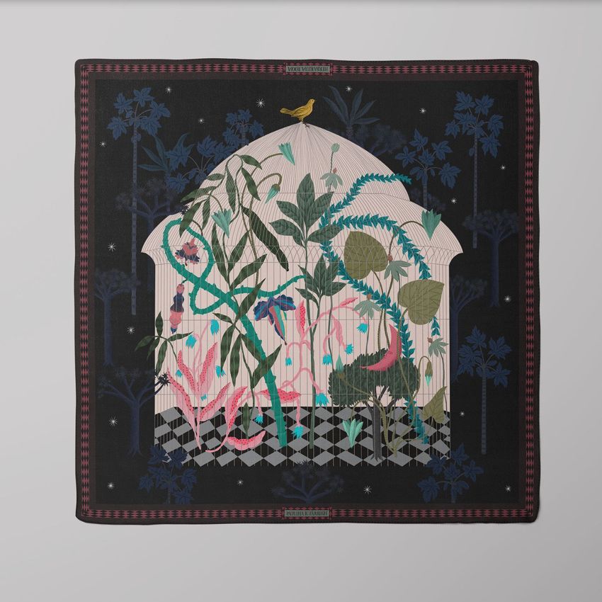 Square silk scarf mockup featuring a botanical illustration with green plants, pink accents, and a bird on a dark background.