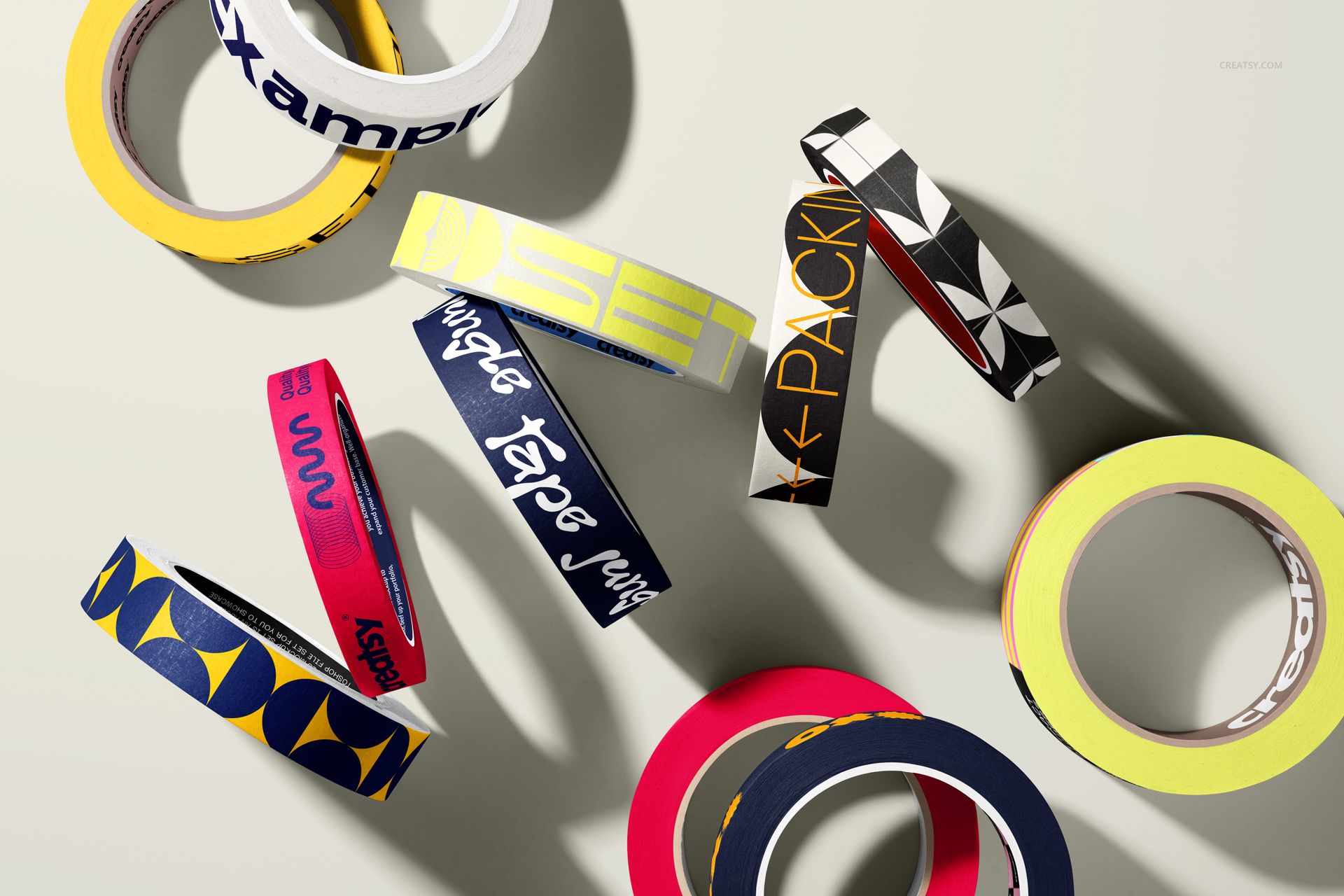 Multiple packaging tape mockups featuring different designs and colors, displayed in a scattered top-down layout.