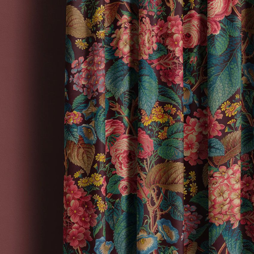 Curtain mockup showing a closeup of rich floral fabric with pink, red, and yellow flowers and green leaves on a dark background.