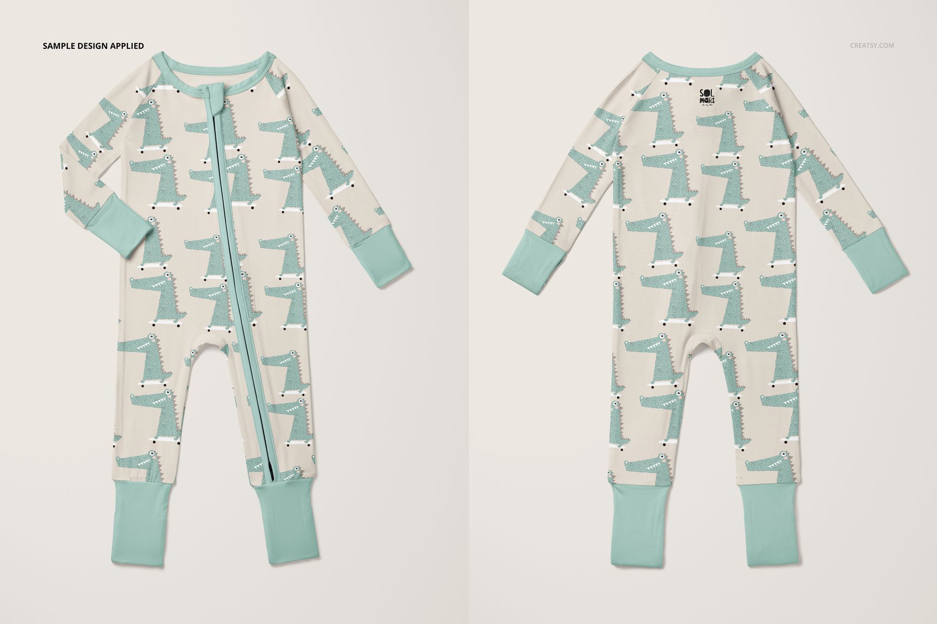 Front and back view of a zip up baby pajama mockup with a playful green and white animal pattern on a light background.