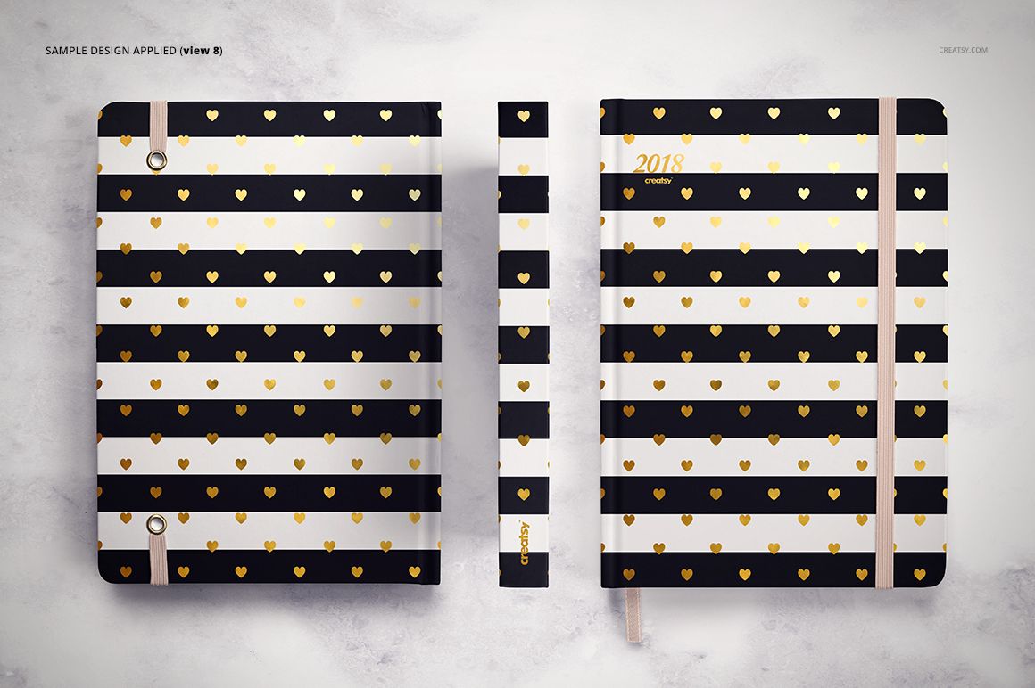 PSD mockup showing a planner with alternating black and white stripes and gold heart accents, displayed flat and upright.