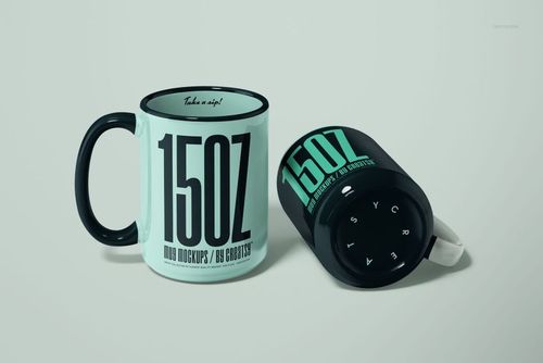 Two 15oz mugs in a mockup scene, one upright and one lying on its side, both with black handles and rims.