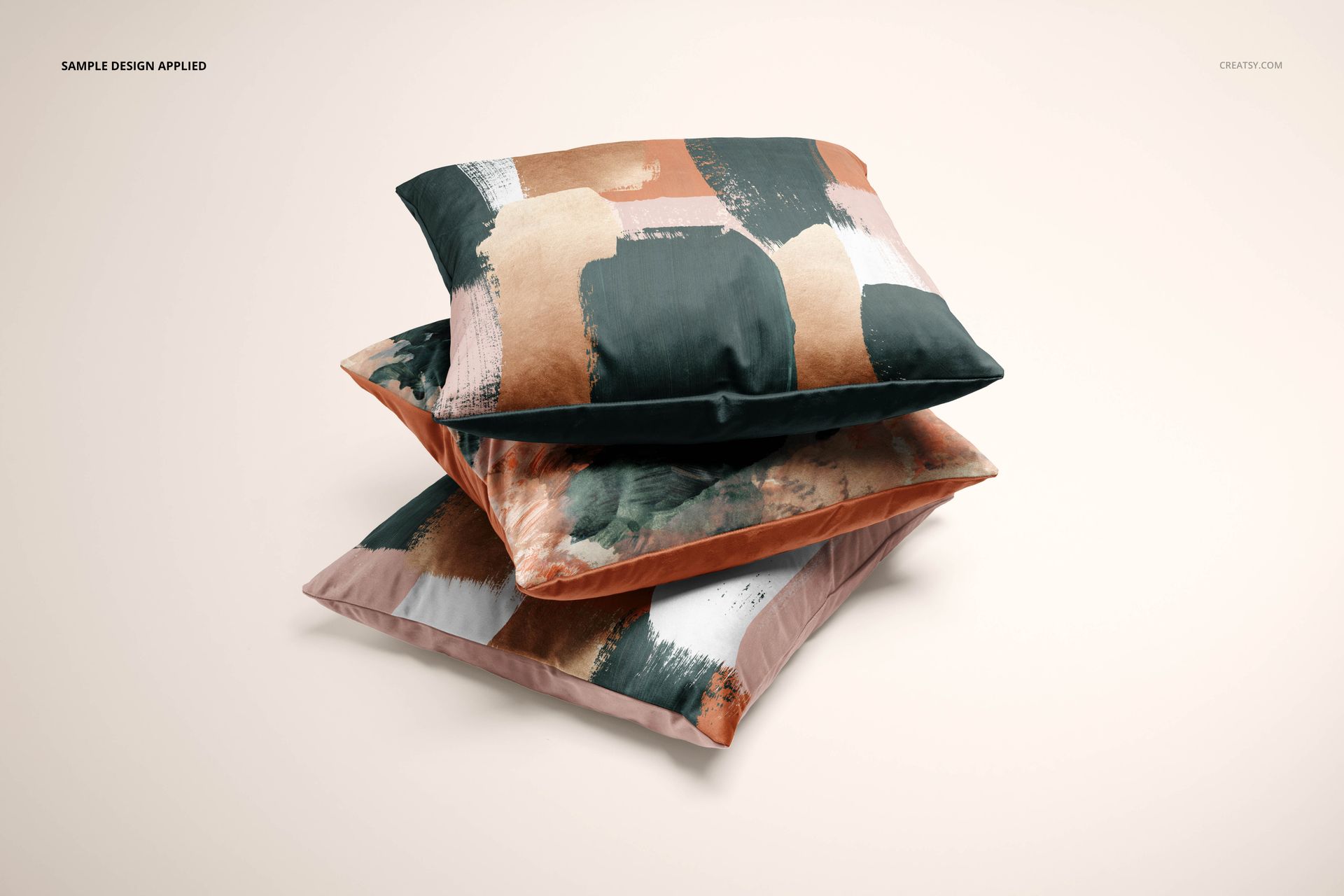 Velvet cushion cover PSD mockup showing layered pillows with artistic brushstroke prints in muted colors against a pale surface.