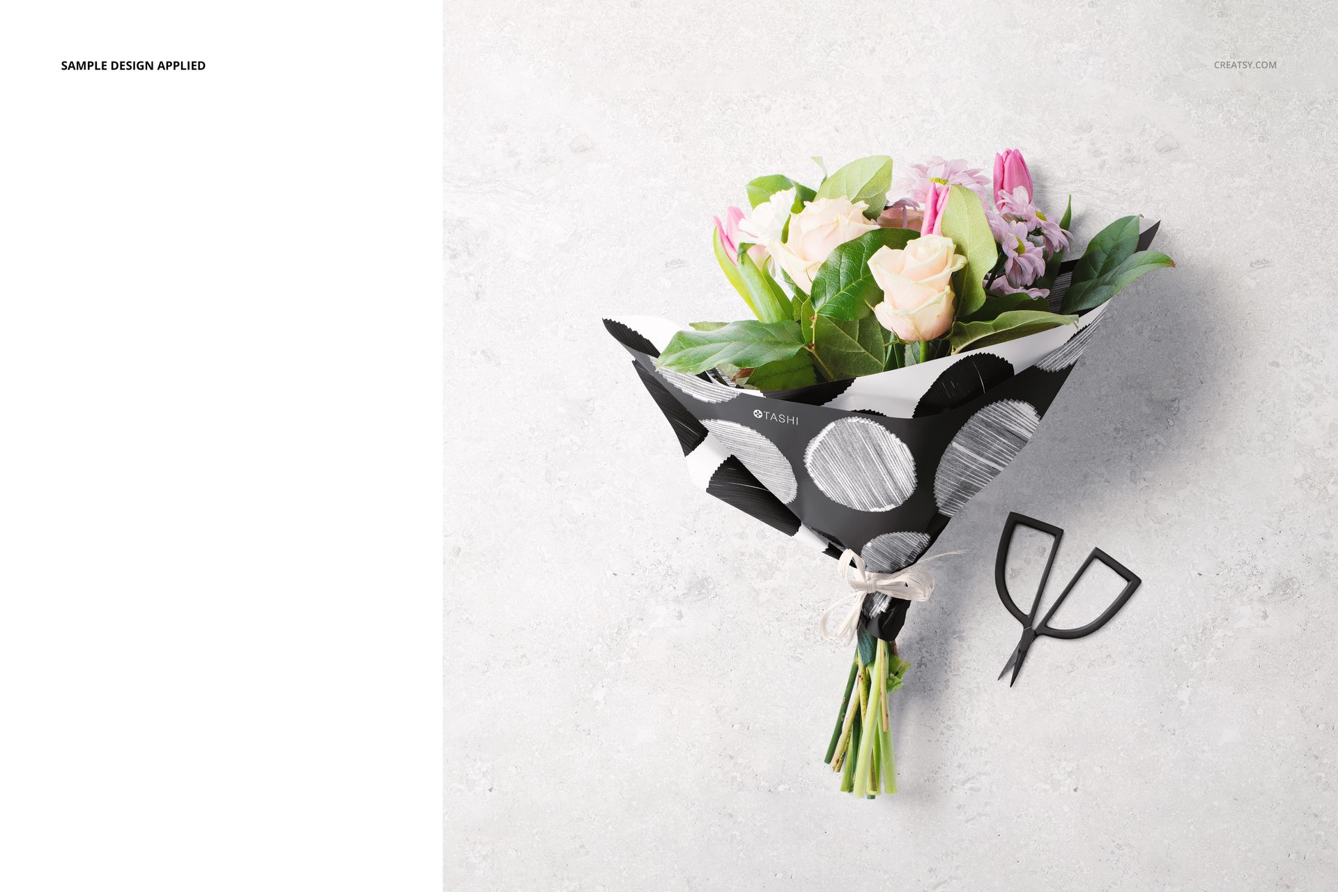 Top view of floral packaging mockup featuring assorted flowers in monochrome wrapping paper with raffia tie.