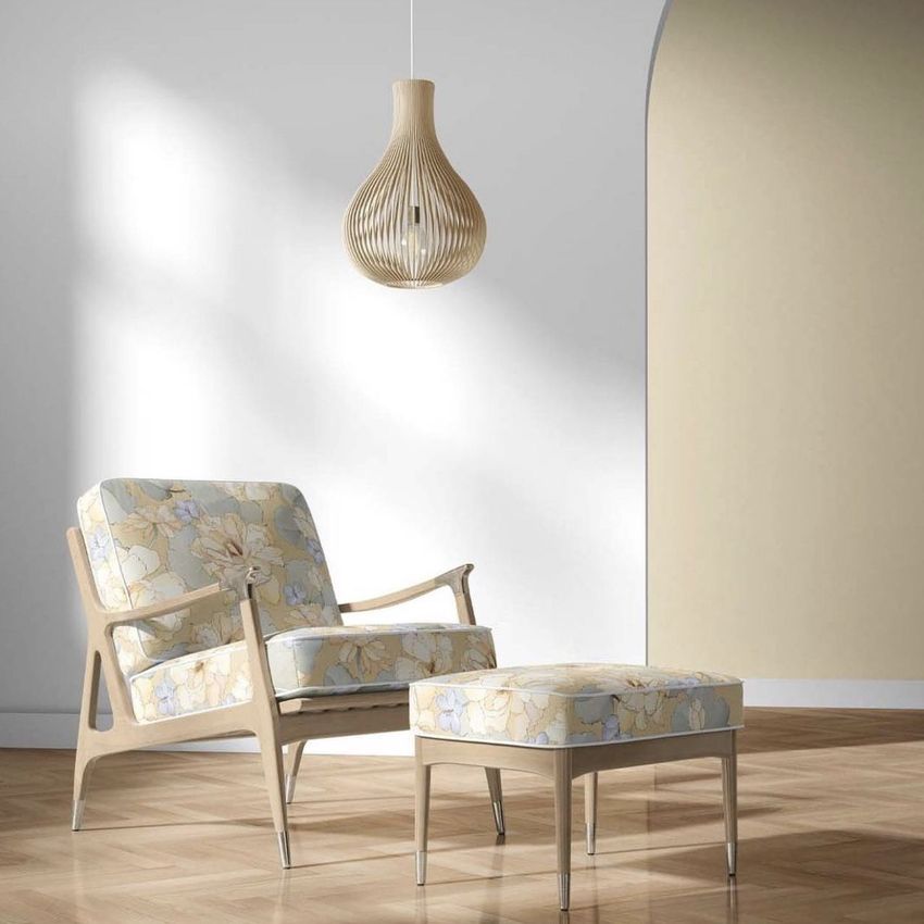 Lounge chair and ottoman mockup set in a modern room with light wood flooring, soft floral upholstery, and a pendant lamp overhead.