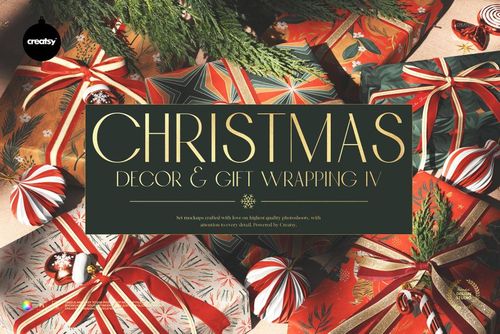 Wrapped gift boxes with ribbons and Christmas ornaments arranged on a surface, viewed from above with festive greenery.