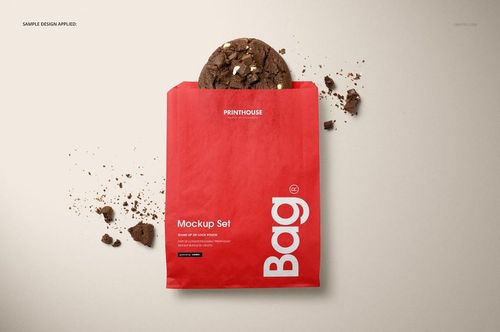 Top view of a red snack paper bag mockup, cookie visible inside, crumbs scattered on light background.