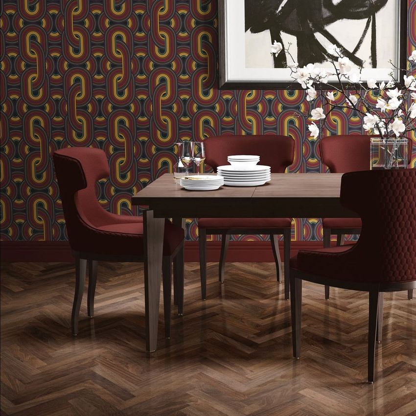 Dining room interior scene mockup featuring a wooden table set with white plates, surrounded by red chairs and geometric patterned wallpaper.