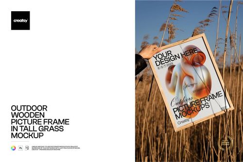 Outdoor wooden picture frame mockup featuring abstract artwork, surrounded by tall dry grass and natural sunlight.