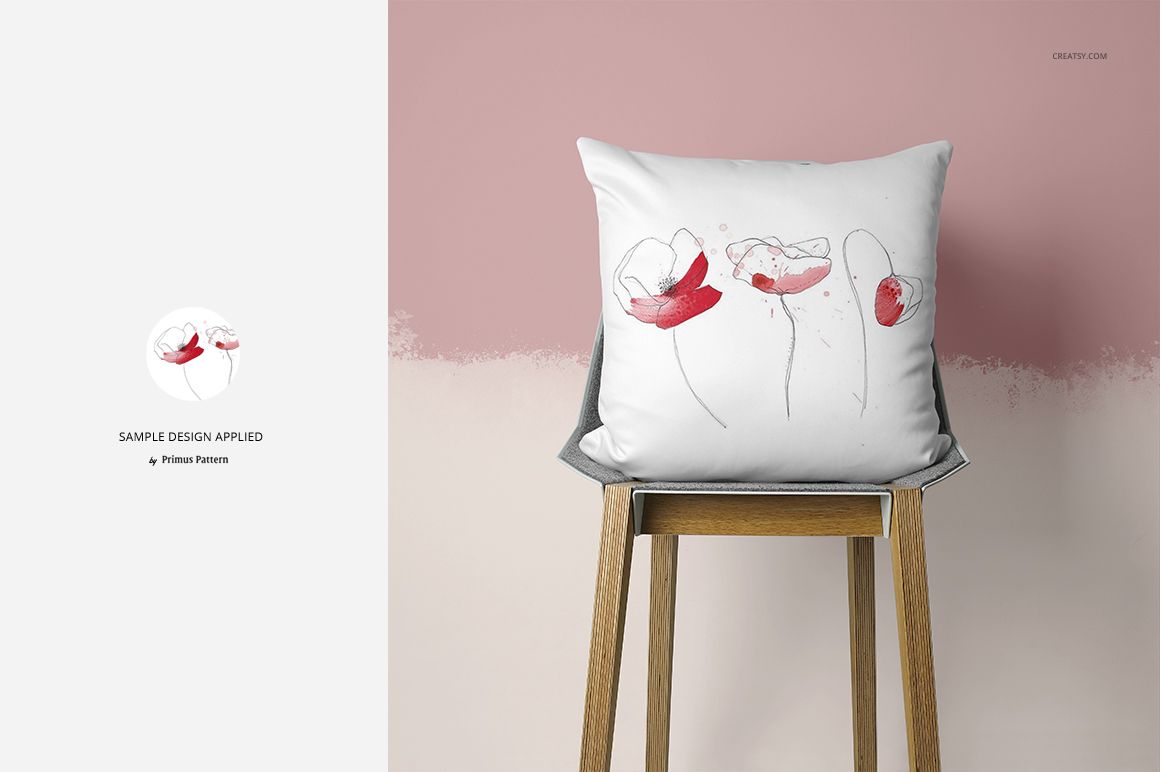 Front-facing pillow mockup featuring simple flower artwork in red and black, placed on a wooden chair.