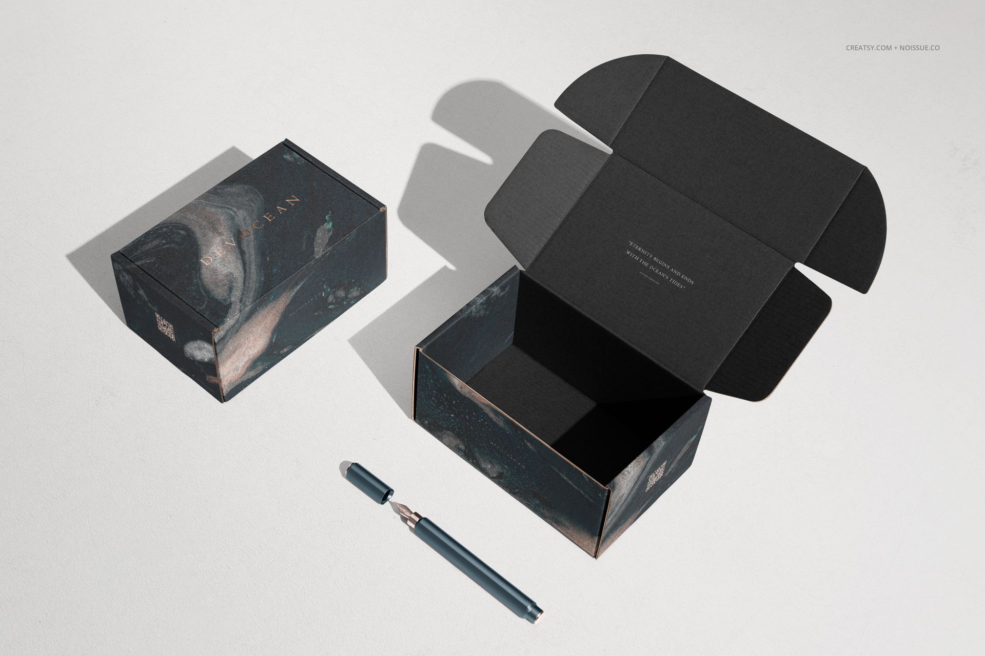 PSD mockup of two packaging boxes, one lid open and one closed, both with black and blue artistic patterns, top perspective.