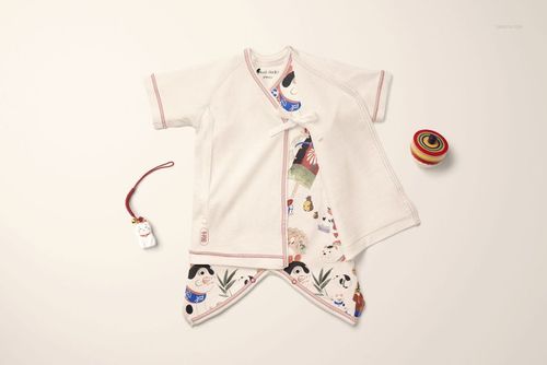 Front view of an organic cotton baby kimono bodysuit mockup with traditional Japanese patterns on a cream background.