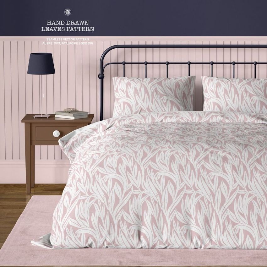 Vintage bedroom bedding mockup showing a bed with pink and white hand-drawn leaf pattern, dark metal frame, and nightstand.