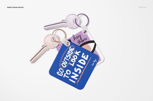 PSD mockup showing three keys with attached square key tags, each displaying vibrant patterns and text, on a light backdrop.