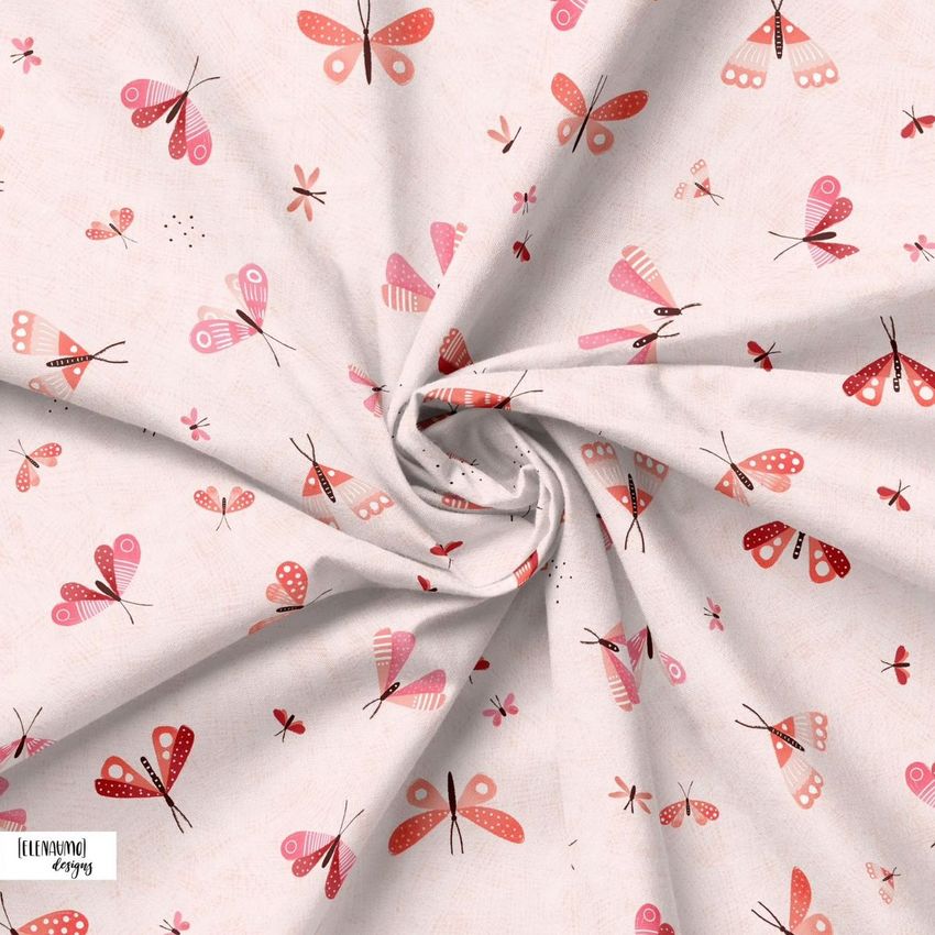 Creased fabric mockup featuring a swirl of light fabric with a pink and red butterfly pattern viewed from above.
