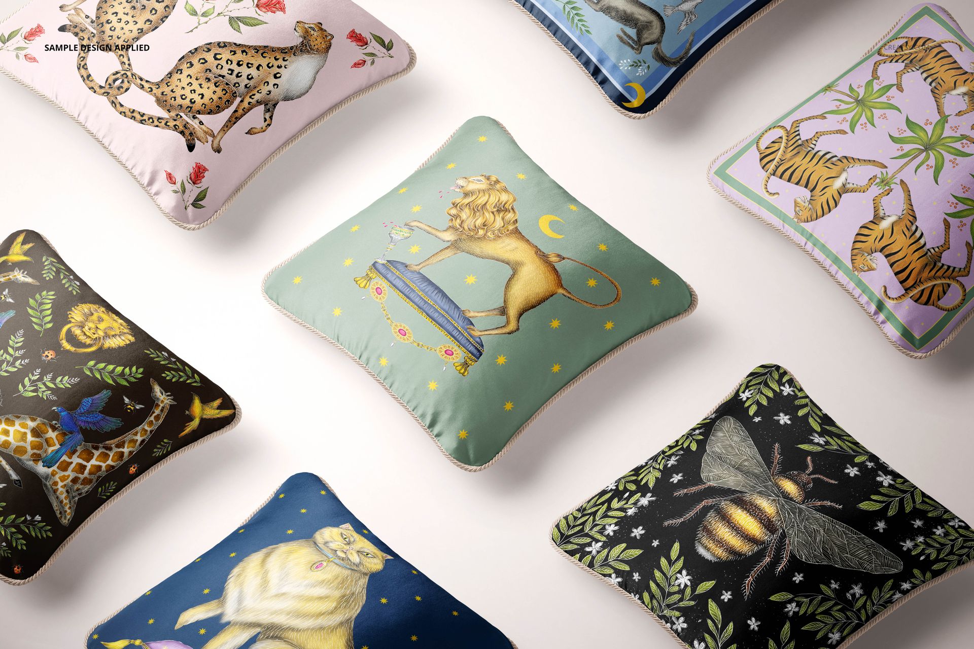 Top view of decorative silk pillows with braided borders, showcasing various animal and botanical motifs in a mockup set.