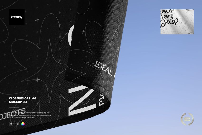 Detailed closeup of a fabric flag mockup with white lettering and shapes, corner edge visible, sky in the background.