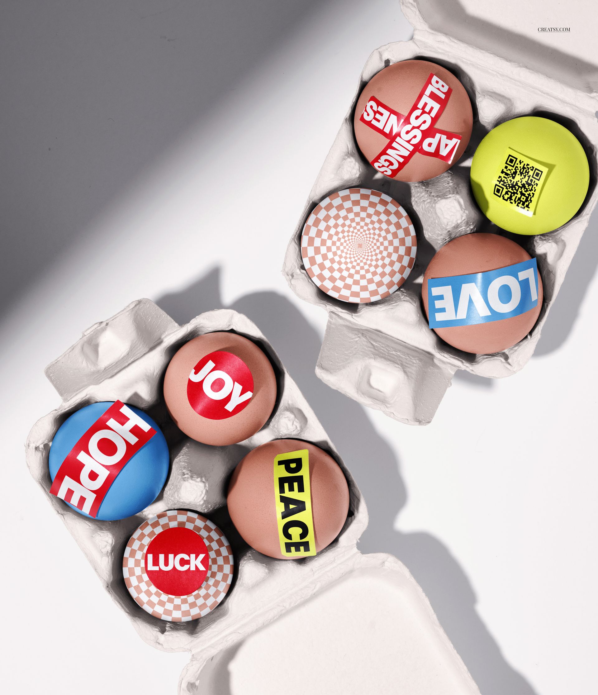 PSD mockup showing Easter eggs in cartons, with graphic designs including words such as PEACE, LUCK, and checkerboard patterns.