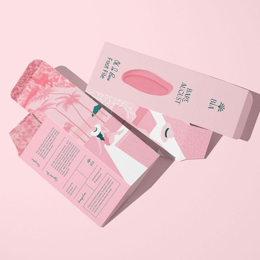 Tuck top crash lock box mockup featuring an open pink packaging box with illustrated graphics and blue text on a light pink background.