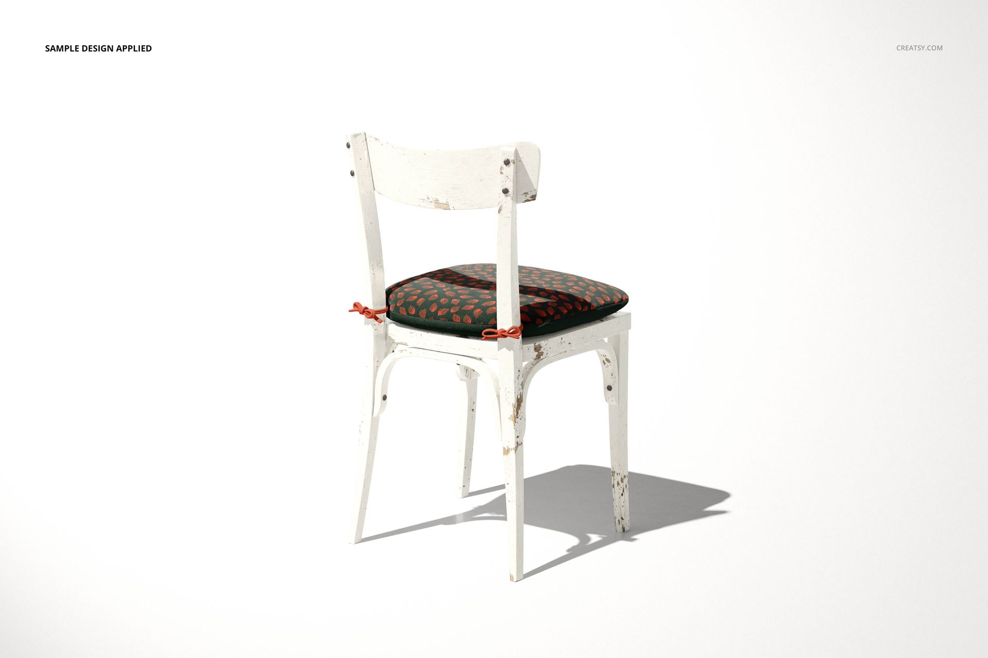 Distressed white wooden chair featuring a dark cushion with a decorative pattern, shown in a PSD mockup scene.