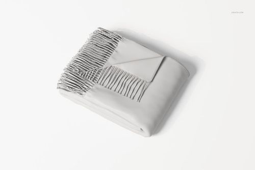 Folded fringe blanket with wrapped corner, shown in a light gray color on a white surface, top view.