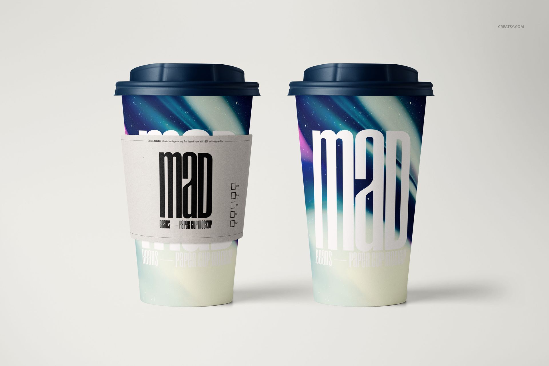 PSD mockup showing a pair of paper coffee cups, abstract multicolor pattern, and one cup with a sleeve.