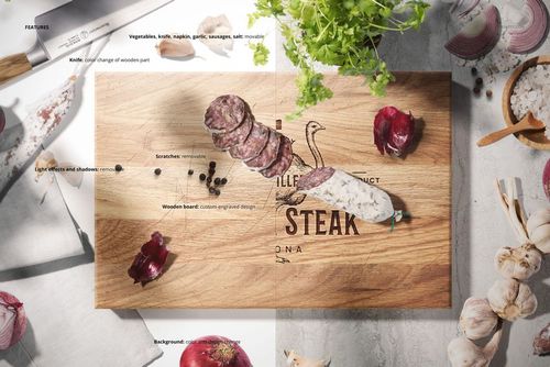 Top view of an engraved end grain wooden cutting board mockup with sliced sausage, herbs, and vegetables around.